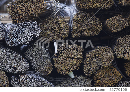 Reinforcing bars with a periodic profile in the packs are stored in the metal products warehouse Reinforcing bars with a periodic profile in the packs are stored in the metal products warehouse 83770106