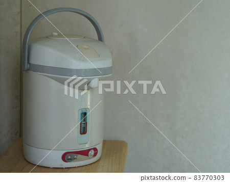 old hot water kettle on wooden chair, old wall background, object, electric, copy space old hot water kettle on wooden chair, old wall background, object, electric, copy space 83770303
