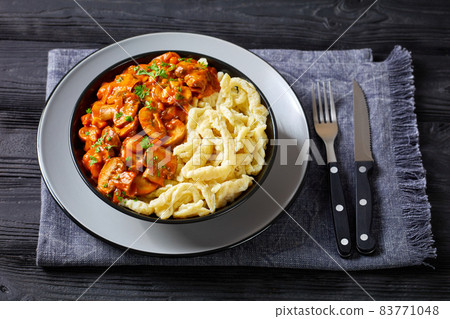 spaetzle with mushroom gravy in a black bowl spaetzle with mushroom gravy in a black bowl 83771048