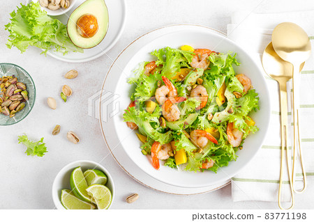Grilled shrimp salad with avocado, mango, lettuce and pistachios, dressed with lime. Healthy food. Ketogenic diet. Top view. Grilled shrimp salad with avocado, mango, lettuce and pistachios, dressed with lime. Healthy food. Ketogenic diet. Top view. 83771198