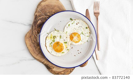 top view breakfast fried eggs plate with cutlery. High quality beautiful photo concept top view breakfast fried eggs plate with cutlery. High quality beautiful photo concept 83772140