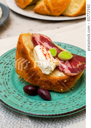 A slice of bread with Bulgarian salami, cheese and chutney 83772592