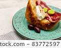A slice of bread with Bulgarian salami, cheese and chutney 83772597