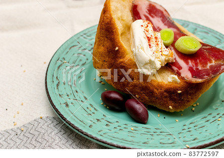 A slice of bread with Bulgarian salami, cheese and chutney A slice of bread with Bulgarian salami, cheese and chutney 83772597