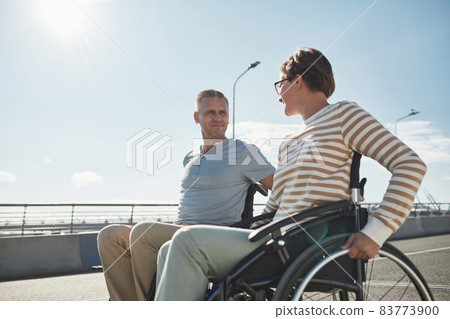 Adult Couple in Wheelchairs Outdoors Adult Couple in Wheelchairs Outdoors 83773900