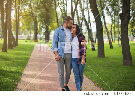 Perfect relationships. Happy couple outdoor. Couple in love Handsome man and attractive girl on a date Perfect relationships. Happy couple outdoor. Couple in love Handsome man and attractive girl on a date 83774682