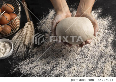 top view chef holding bread dough. High quality beautiful photo concept top view chef holding bread dough. High quality beautiful photo concept 83776043