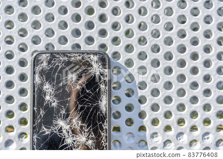 A smartphone with a broken screen when dropped A smartphone with a broken screen when dropped 83776408