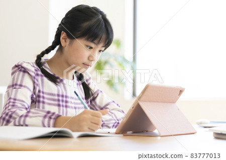 Girls in the upper grades of elementary school studying with a tablet Girls in the upper grades of elementary school studying with a tablet 83777013