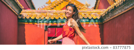 China travel Asian woman tourist smiling happy in Beijing city, panoramic banner young people lifestyle. 83777875