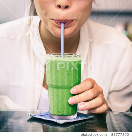 Green smoothie drink healthy detox diet woman drinking matcha tea cold juice beverage. Square crop for social media. 83777890