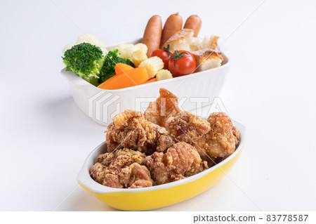 Chicken and colorful steamed vegetables Party dishes lined up on a white background Chicken and colorful steamed vegetables Party dishes lined up on a white background 83778587