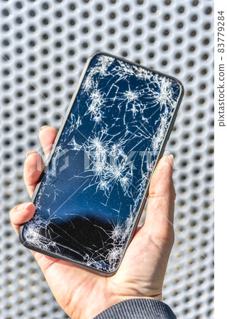 Smartphone fence background with broken screen after dropping Smartphone fence background with broken screen after dropping 83779284