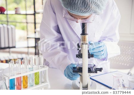 Woman scientist in lab look at science microscope medical test and research biology chemistry. Females technician laboratory analyzing scientific pharmacy genetic research. Chemistry Medical test lab Woman scientist in lab look at science microscope medical test and research biology chemistry. Females technician laboratory analyzing scientific pharmacy genetic research. Chemistry Medical test lab 83779444