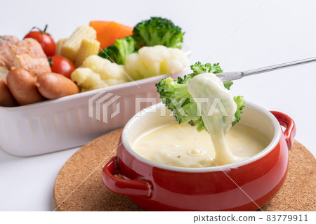 White table with cheese hondu and colorful steamed vegetables party dishes White table with cheese hondu and colorful steamed vegetables party dishes 83779911