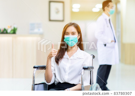 Asian woman patient showing thump up during sitting on wheelchair at hospital,Health insurance concept Asian woman patient showing thump up during sitting on wheelchair at hospital,Health insurance concept 83780307