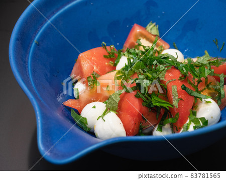 Caprese of tomato and mozzarella cheese. Japanese style topped with perilla. 83781565