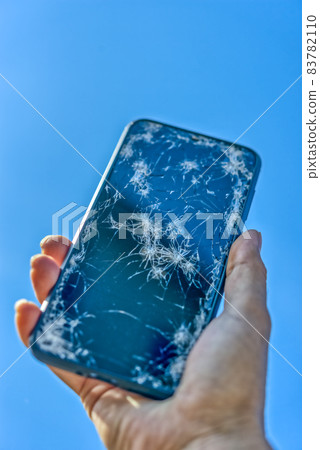Smartphone with a broken screen after dropping Blue sky back 83782110