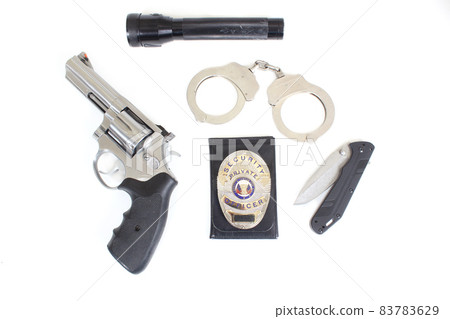 Handgun With Security Badge and Handcuffs on White Background 83783629