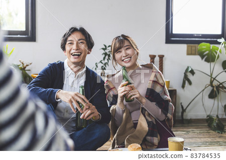 Young people having a home party 83784535