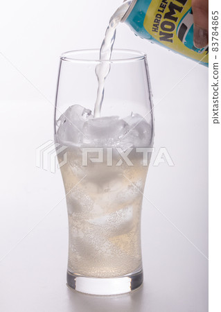Drinks poured into a glass on a white background 83784865