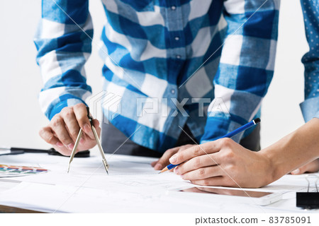 Designers discuss architecture project in office 83785091