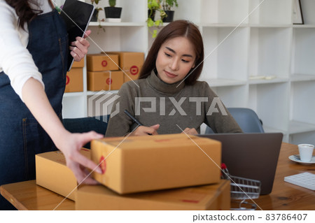Two asian woman working together for SME project. Young Owner people startup for Business Online, SME, Delivery Project. Online Business Concept 83786407