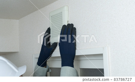 Image of a worker who inspects and cleans the ventilation fan of the bath Image of a worker who inspects and cleans the ventilation fan of the bath 83786727