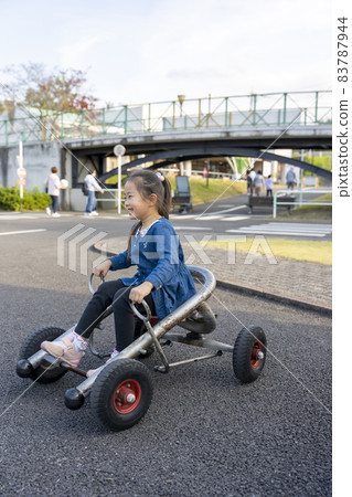 A girl riding a cycle cart in the Kanagawa Forest A girl riding a cycle cart in the Kanagawa Forest 83787944
