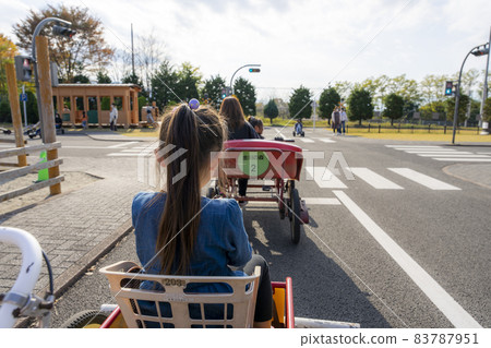 A girl riding a cycle cart in the Kanagawa Forest A girl riding a cycle cart in the Kanagawa Forest 83787951