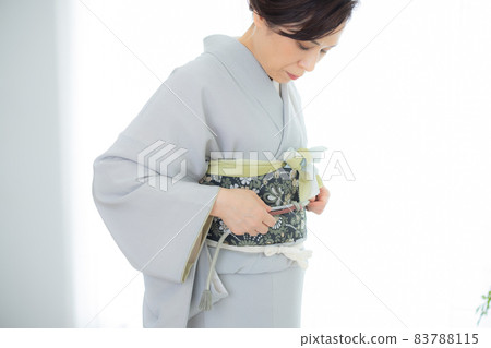 A woman who wears a kimono by herself A woman who wears a kimono by herself 83788115