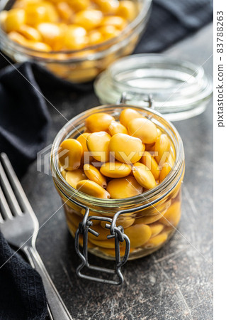 Pickled yellow Lupin Beans in jar. 83788263