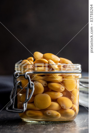 Pickled yellow Lupin Beans in jar. 83788264