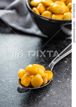 Pickled yellow Lupin Beans in spoon. Pickled yellow Lupin Beans in spoon. 83788268