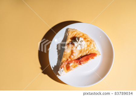 Slice of pizza with seafood on white plate 83789034