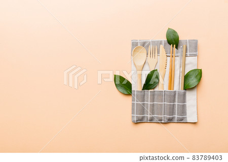 Eco friendly reusable recyclable white eco bag with kitchenware on Colored background. Concept zero waste 83789403