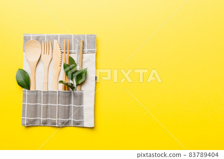 Eco friendly reusable recyclable white eco bag with kitchenware on Colored background. Concept zero waste Eco friendly reusable recyclable white eco bag with kitchenware on Colored background. Concept zero waste 83789404