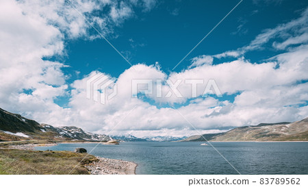 Oppland, Tyin Lake, Norway. Stones On Coast Of Beautiful Lake Tyin In Summer Day. Norwegian Nature. 4K 83789562