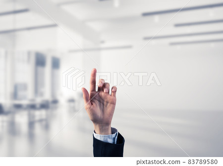 Choosing gesture of businessperson in elegant modern interior in sunshine light Choosing gesture of businessperson in elegant modern interior in sunshine light 83789580