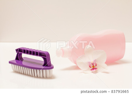 Bottle of dishwashing liquid and brush on white background. 83791665