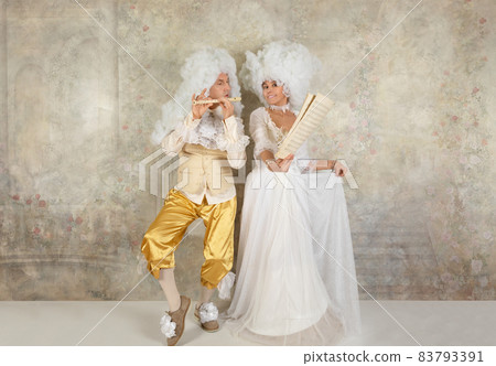 Fun couple in Baroque style clothes in studio Fun couple in Baroque style clothes in studio 83793391