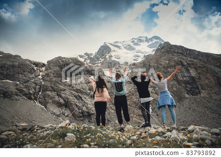 A group of friends climbed high in the mountains A group of friends climbed high in the mountains 83793892