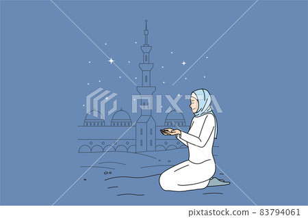 Muslim woman in traditional clothes pray near mosque  83794061