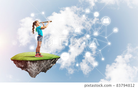 Concept of careless happy childhood with girl looking in spyglass 83794812