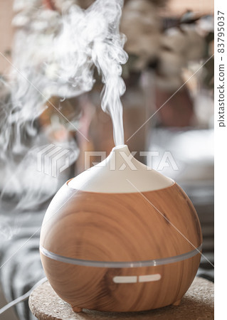 Modern oil aroma diffuser close up on a blurred background. Modern oil aroma diffuser close up on a blurred background. 83795037