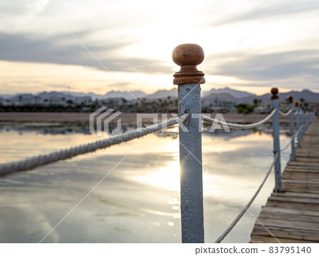 The background is a beautiful wooden long pier 83795140