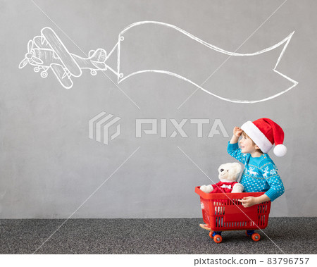 Happy child riding shopping cart. Christmas holiday concept Happy child riding shopping cart. Christmas holiday concept 83796757