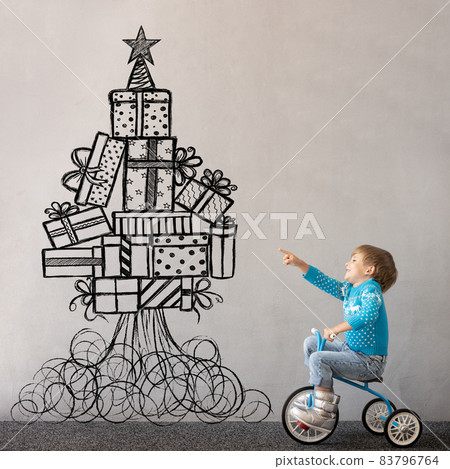 Happy child wearing Christmas sweater Happy child wearing Christmas sweater 83796764