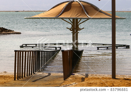 Sandy beach on the shores of the Dead Sea (Sodom Sea) in the desert in southern Israel. Sandy beach on the shores of the Dead Sea (Sodom Sea) in the desert in southern Israel. 83796881