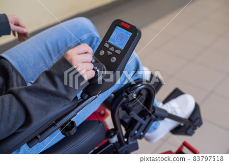 Close-up of a female hand on the control handle of an electric wheelchair Close-up of a female hand on the control handle of an electric wheelchair 83797518